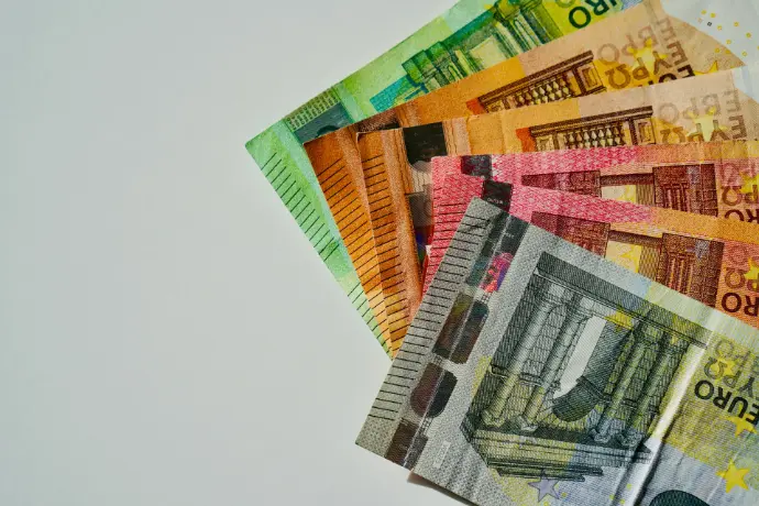 a pile of mexican currency sitting on top of each other